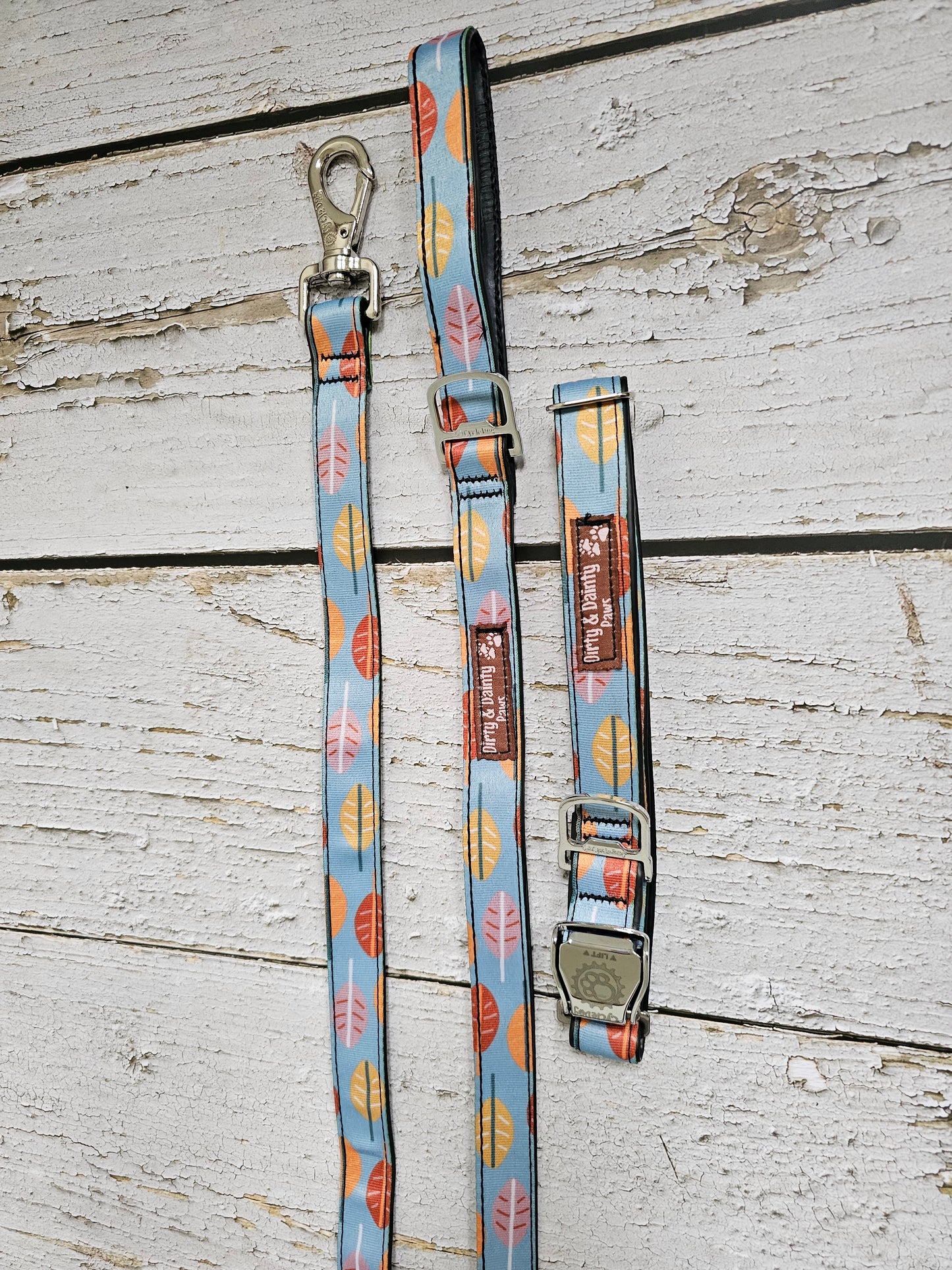 Boho Fall Leaves Dog Leash made from re-purposed bicycle tires, featuring a bottle opener attachment for poop bag holders. Waterproof, naturally antibacterial, and machine washable. Blue leash with fall color leaves