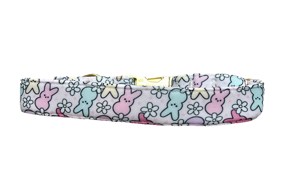 Adjustable neoprene dog collar featuring a pastel Easter Peeps bunny pattern, displayed on a soft faux fur background.