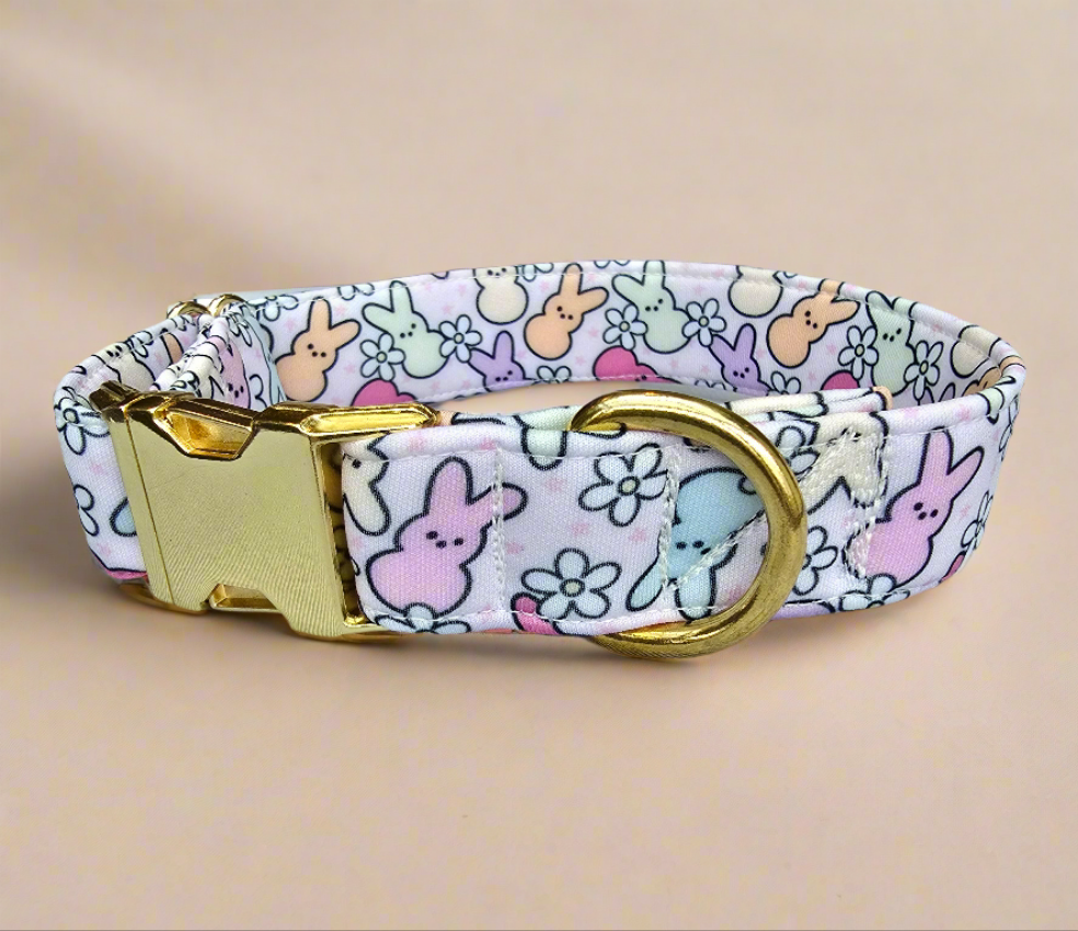 Adjustable neoprene dog collar featuring a pastel Easter Peeps bunny pattern, displayed on a soft faux fur background.