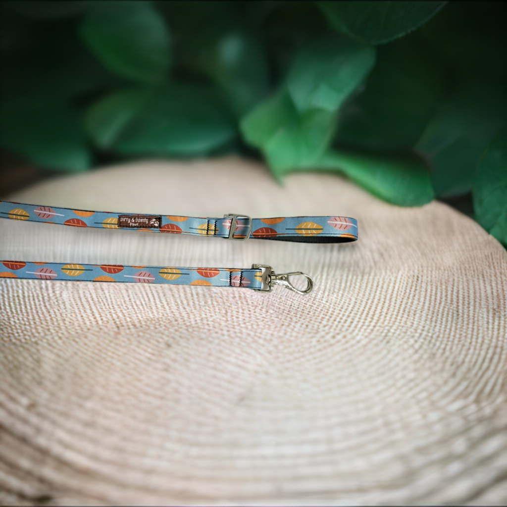 Boho Fall Leaves Dog Leash made from re-purposed bicycle tires, featuring a bottle opener attachment for poop bag holders. Waterproof, naturally antibacterial, and machine washable. Blue leash with fall color leaves