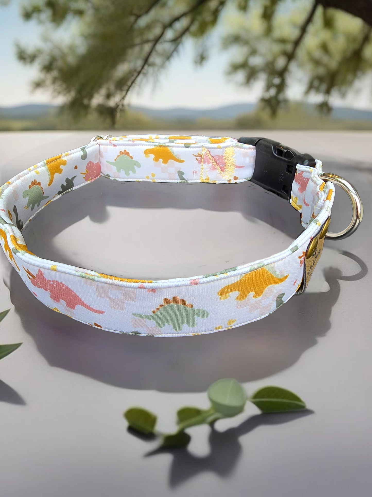 neutral tone dinosaurs that are yellow, green and salmon color dog collar
