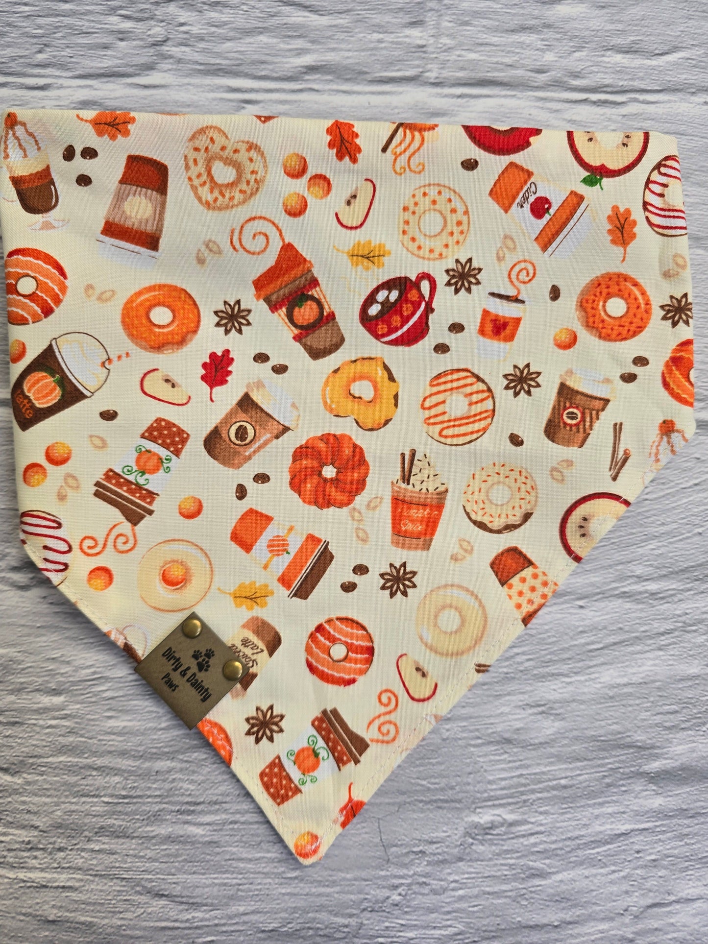 Reversible side of the fall-themed dog bandana showcasing a playful print of autumn treats like donuts, coffee cups, and pumpkin spice lattes.