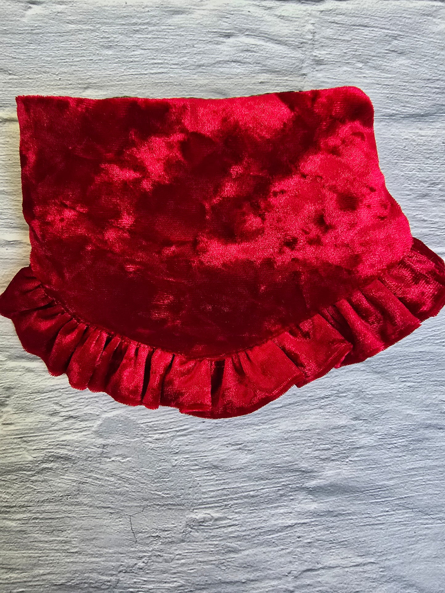  Dog wearing a Pinecone Ruffle Scrunchie Dog Bandana with a pinecone and evergreen design, accented by a red shimmering ruffle trim