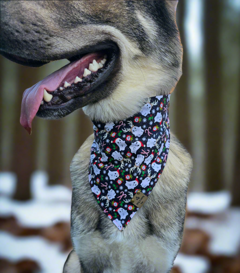 Reversible dog bandana with a "Ghosts of Spooky Christmas" print on one side and a shimmering red plaid design on the other