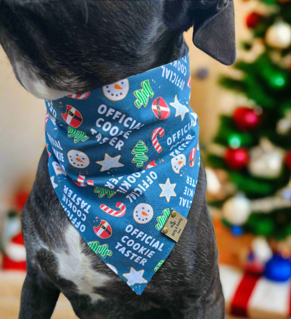 Reversible dog bandana with "Official Cookie Taster" print featuring holiday cookies, candy canes, and Christmas flowers.