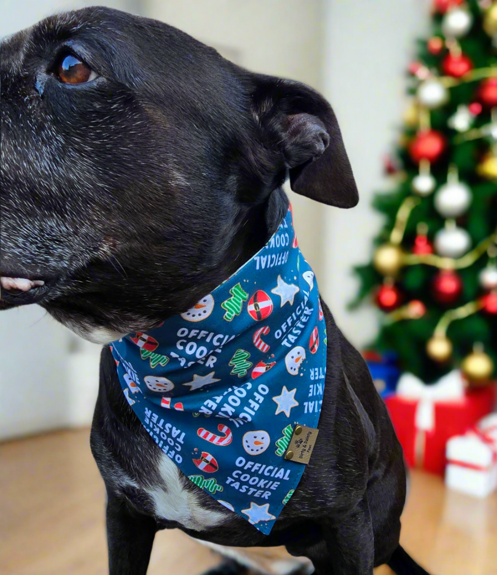 Reversible dog bandana with "Official Cookie Taster" print featuring holiday cookies, candy canes, and Christmas flowers.