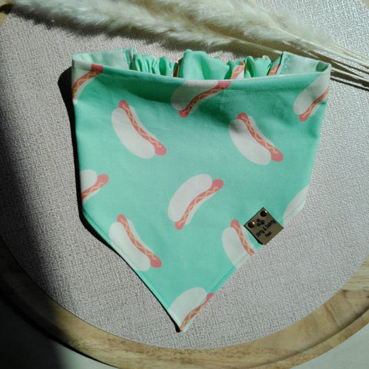 Teal bandana with hot dog pattern on a wooden surface