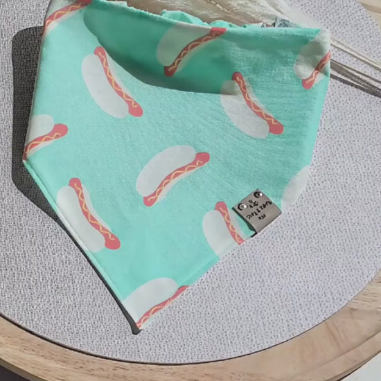 Reversible Cozy Cotton dog bandana featuring a playful hot dog print on mint green fabric with a coordinating mint polka dot reverse side. Handmade scrunchie dog bandana by Dirty and Dainty Paws