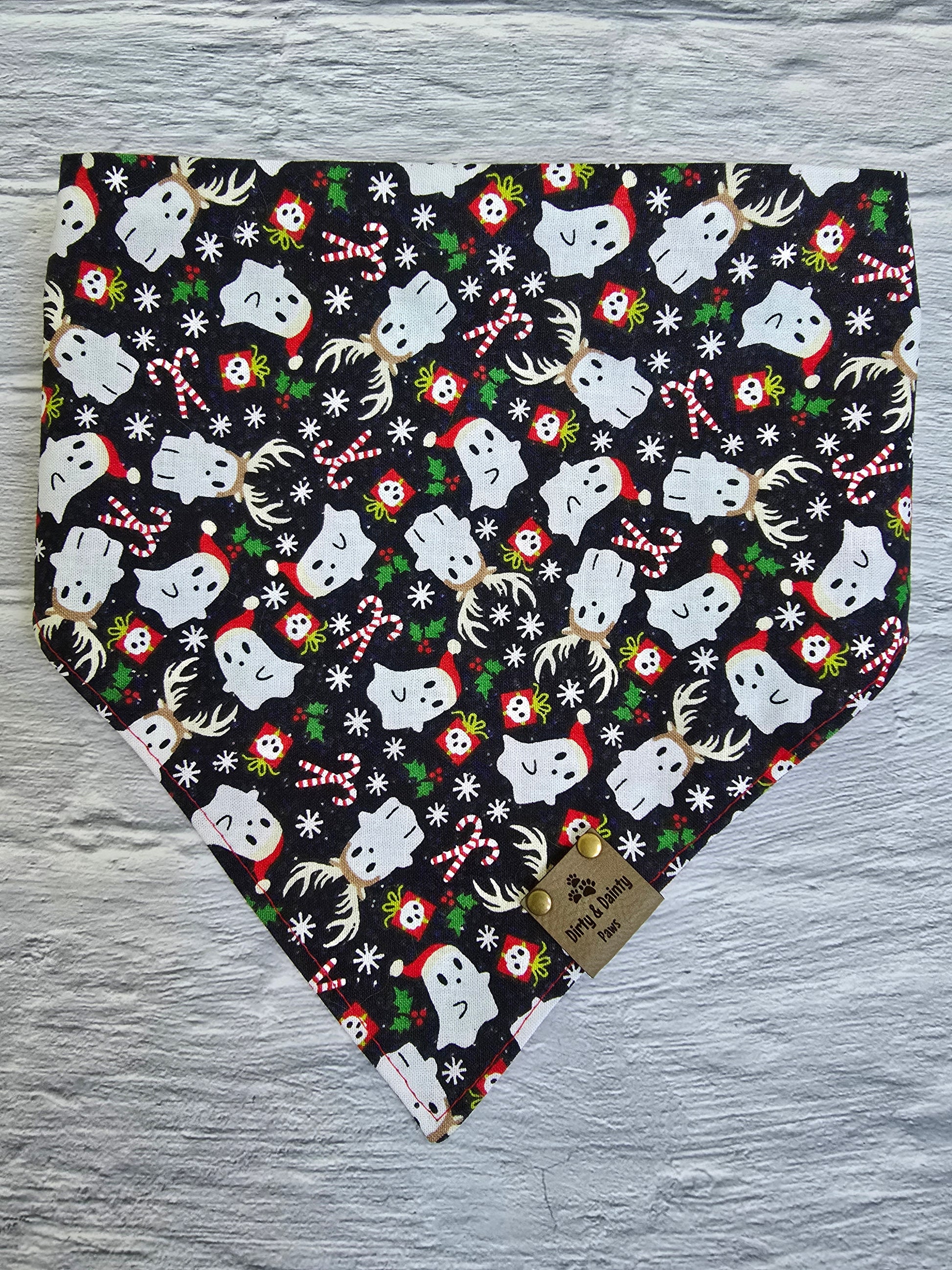 Reversible dog bandana with a "Ghosts of Spooky Christmas" print on one side and a shimmering red plaid design on the other