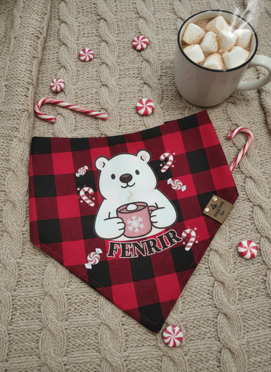 Red and black checkered bandana with a polar bear design and 'Fenrir' text, placed on a textured surface with candy canes and a mug of hot chocolate.