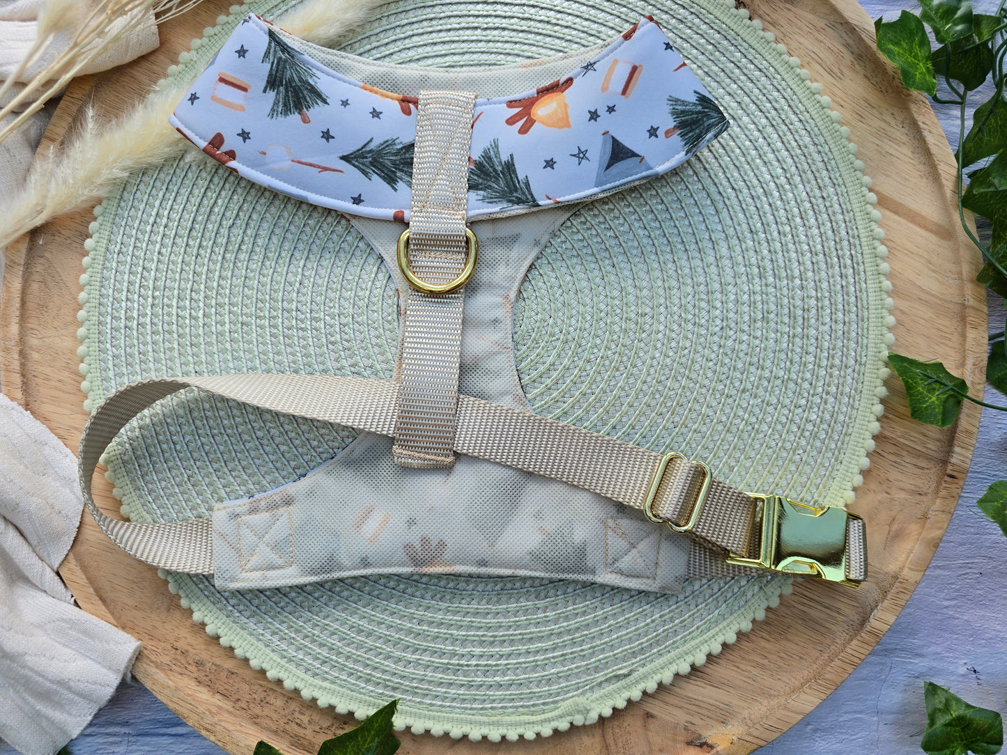 The back of the dog harness shows the almond colored webbing with matching mesh over the neoprene and showing the yellow gold brass D ring and buckle